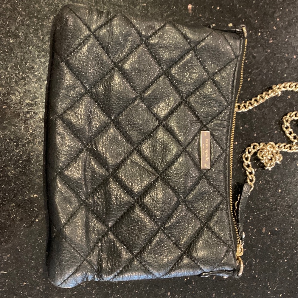 Kate Spade quilted black crossbody with gold chain.